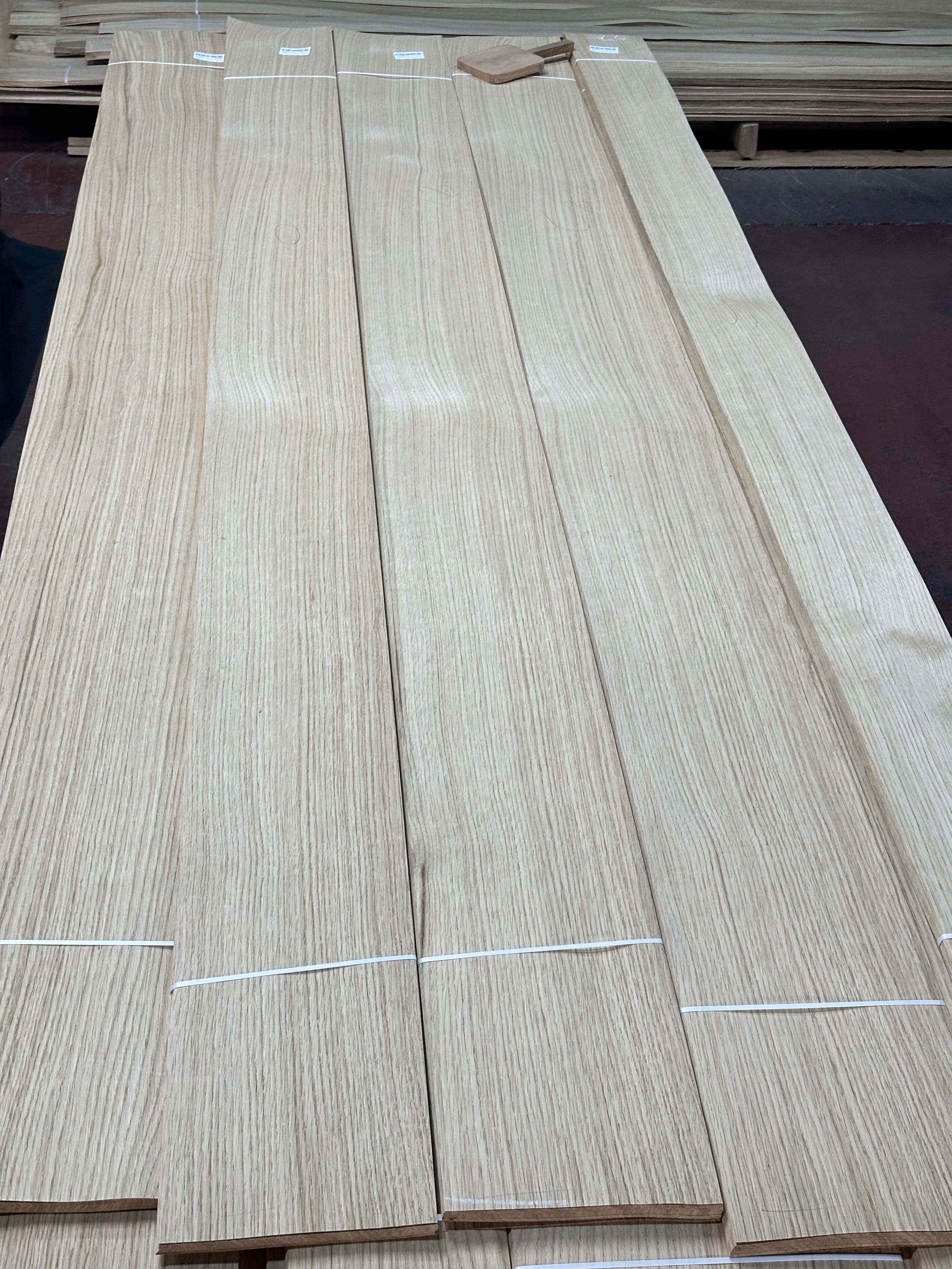 Sliced white oak veneer leaves banded in bundles on the mill floor