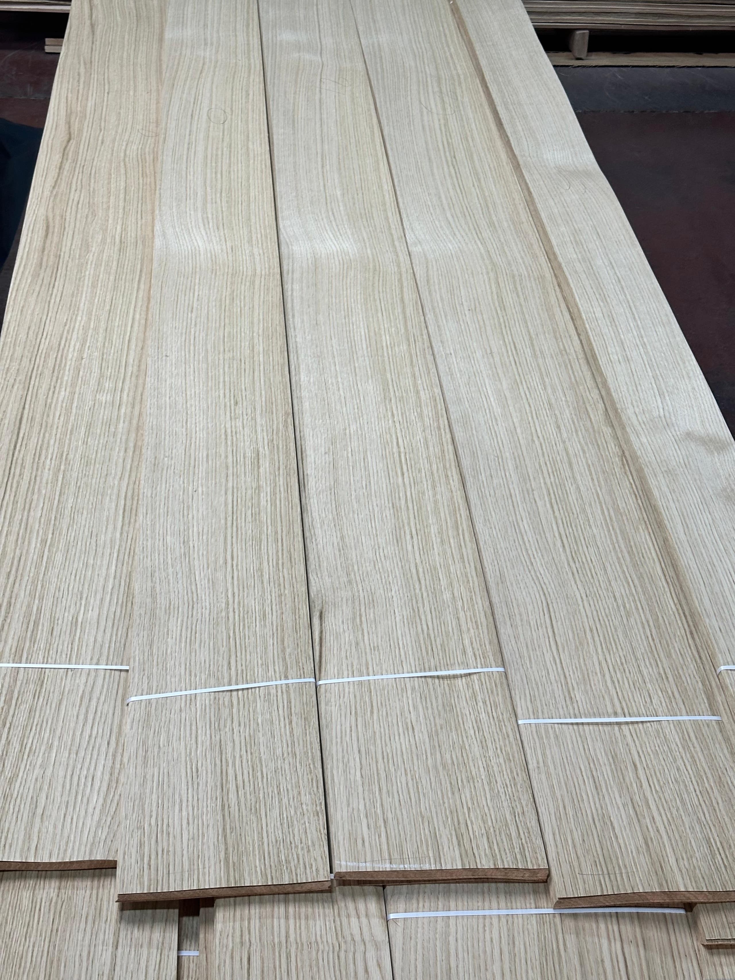 Sliced white oak veneer leaves banded in sequence, showing straight even grain